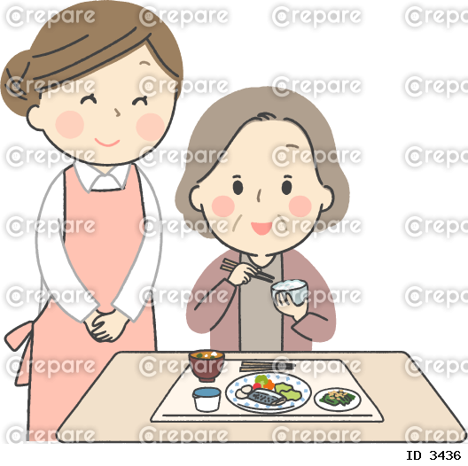 食事をするシニア女性と介護士の女性